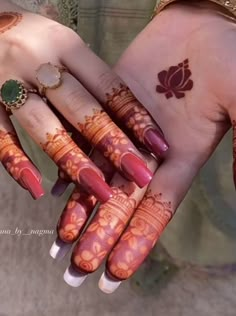 two hands with henna designs on them