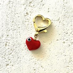 This red heart bag charm will upgrade any bag or purse.Charms for bags are the new trend to give your bags a trendy look with our colorful charms.Easy to put on any bag, the charm hangs on a heart-shaped lobster clasp so you can easily move the charm on any bag you want.Personalize your look with this red heart bag charm. Everyday Heart Shaped Removable Charms, Elegant Red Jewelry With Heart Charm, Trendy Bag Charm With Lobster Clasp As Gift, Elegant Red Charm Bracelet With Heart Charm, Everyday Heart-shaped Removable Charms, Adjustable Heart-shaped Charms Jewelry, Heart-shaped Charms With Removable Details For Everyday, Everyday Heart-shaped Charms With Removable Features, Red Heart-shaped Necklaces With Charms