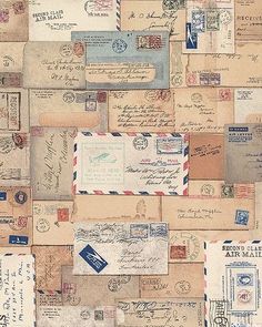 an image of many old mail envelopes on the wall with letters and stamps all over them