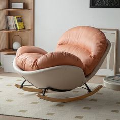 a living room with a rocking chair and bookshelf on the wall behind it