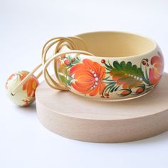 "Hand Painted Floral Wooden Bracelet An original hand painted Wooden Bracelet and/or Necklace set decorated in the classic Ukrainian folk art style of PETRYKIVKA painting. Add some ethnic style to your wardrobe or give a unique Christmas, Wedding or Birthday gift to friends and family. The item made from wood with tempera paint. It securely covered with a protective varnish. 100% Water Resistant аnd Eco-Friendly. The wood jewelry is light in weight. * Pendants are painted on both sides and comes Ukrainian Folk Art, Folk Art Jewelry, Colorful Bangles, Wooden Bangle, Wooden Bracelet, Hand Painted Jewelry, Hand Painted Silk Scarf, Hand Painted Silk, Sustainable Jewelry