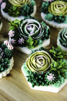 some green and white cupcakes with flowers on them