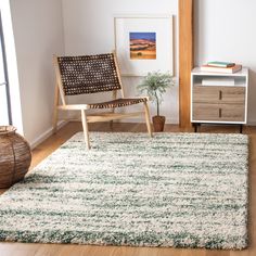 a living room with a chair and rug on the floor