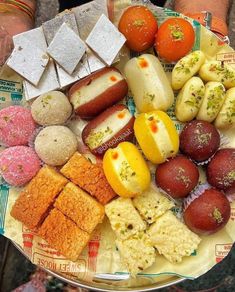 a plate filled with different types of food on top of a paper towel next to two hands