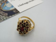 spectacular vintage gold tone KARATCLAD SIGNED stunning cocktail ring, beautiful ornate design with deep red rhinestones, high end great condition , size M Ornate Gold Ruby Ring, Vintage Jeweled Rings For Party, Vintage Gold Jeweled Rings, Ornate Gold Ring With Ruby, Ornate Gold Rings With Ruby, Vintage Gold Ruby Ring Collectible, Vintage Collectible Ruby Ring, Vintage Gold Ruby Ring, Cocktail Vintage