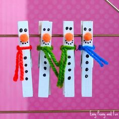 four snowmen made out of popsicle sticks