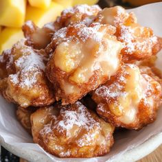 powdered sugar covered pastries in a white bowl