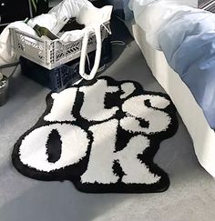 a black and white rug with the word do or die on it next to a bed