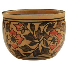 a brown and black bowl with flowers on the inside is sitting in front of a white background