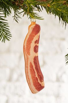 a bacon ornament hanging from a christmas tree