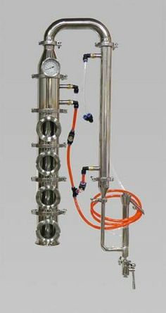 a large metal apparatus with orange hoses attached to it's sides and two gauges on each side