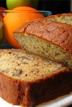 two slices of banana bread sitting on top of a white plate next to an orange