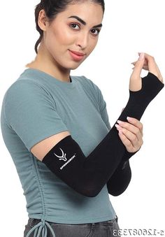 a woman wearing an arm cast and holding her hand up to the side with one arm