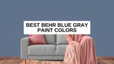 a couch sitting on top of a hard wood floor next to a blue painted wall