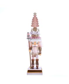 a nutcracker figurine with a christmas tree on top