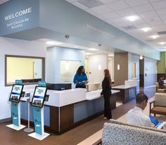 people are waiting in line at the check - in desk