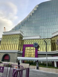 a large building with a purple and yellow design on it's front entrance area