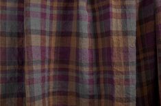 a close up view of a purple and brown plaid fabric