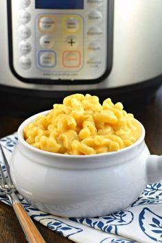 a white bowl filled with macaroni and cheese next to an instant pressure cooker