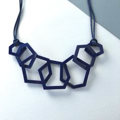 Modern navy blue mid-century geometric necklace which is perfect for the woman who likes contemporary design. My necklaces are light and easy to wear and will give your favourite outfit an instant pop of colour. This seven link necklace is my 'between' size, not as dramatic as my twelve link necklace and more of a statement than the three link one. It is mid-length and measures 26 inches long and hangs 13.5 inches from the clasp to the bottom link.  Three sizes of laser cut geometric shapes meas Modern Blue Necklace, Modern Geometric Blue Jewelry, Modern Blue Geometric Jewelry, Black Tissue Paper, Ribbon Necklace, Bib Necklaces, Ball Necklace, Acrylic Jewellery, Geometric Necklace