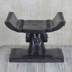 a black sculpture on top of a wooden table