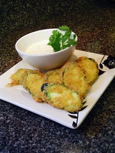 some food is on a white plate with a bowl of ranch dressing next to it