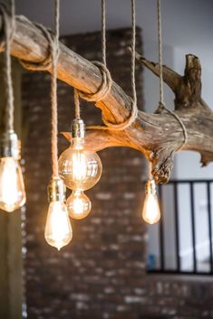 some light bulbs hanging from a wooden beam