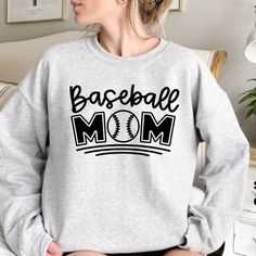 a woman wearing a sweatshirt that says baseball mom