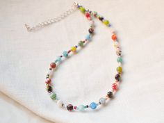 This millefiori glass bead necklace is so colorful and cute. In this silver-plated necklace, I have paired colorful millefiori glass beads with tiny glass seed beads. The beading wire I use is high-quality stainless steel, composed of multiple twisted tiny wires that are nylon coated to protect the beads. This necklace adds color to any outfit and is both laid-back and cool at the same time. Also available gold-plated - just send me a message. The length of the necklace is 15 inches (38 cm), wit Flower Bead Jewelry, Colorful Choker, Necklace Colorful, Beading Wire, Silver Plated Necklace, Glass Seed Beads, Colourful Necklace, Glass Bead Necklace, Gold Plated Necklace