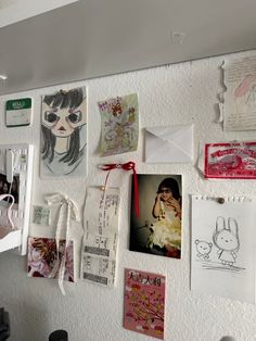 a white refrigerator covered in magnets and pictures