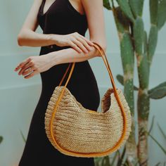 A sturdy double leather straps wrap the edge trim on the front and back of this roomy tote bag handwoven from raffia in a slightly slouchy silhouette to carry all your essentials. Perfect for the beach day and your summer road trips. Wipe clean with a damp cloth. Material: Raffia body and Leather handles. Modern Handwoven Straw Bag For Everyday Use, Chic Woven Leather Shoulder Bag, Modern Straw Shopping Bag, Chic Beach Bag With Round Handle For Shopping, Chic Jute Crochet Bag With Leather Handles, Chic Crochet Jute Bag With Leather Handles, Chic Natural Color Hobo Bag, Chic Straw Bag With Natural Fiber, Chic Everyday Handwoven Hobo Bag