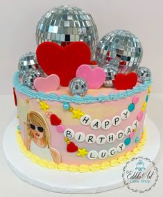 a birthday cake decorated with disco balls and decorations