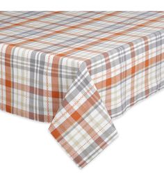 an orange and grey plaid tablecloth with white trim