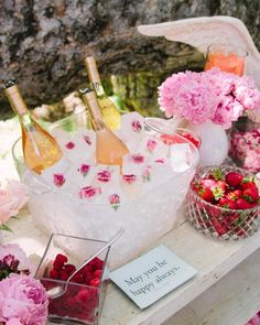 flowers and bottles of wine on a table