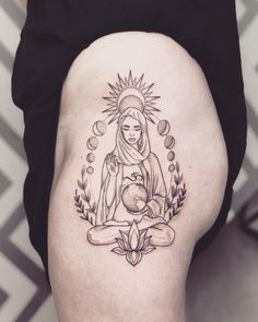 a woman with a tattoo on her thigh holding a ball and sitting in the middle