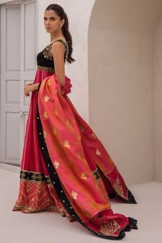 Add depth and femininity to your festive wardrobe with this panelled cranberry coloured khaddi silk two-tone peshwas with an attached velvet bodice. The brocade stole is finished with velvet and printed borders. Red Tissue Silk Kurta With Traditional Drape, Red Chanderi Lehenga With Dabka Detailing, Red Anarkali Tissue Silk Kurta, Red Tissue Silk Anarkali Dupatta, Red Anarkali Tissue Silk Dupatta, Red Raw Silk Lehenga With Dabka, Traditional Drape Raw Silk Choli With Dabka, Anarkali Brocade Dupatta With Dabka Detailing, Anarkali Brocade Dupatta With Dabka