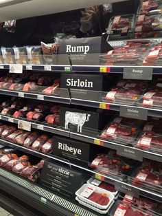 the shelves in a grocery store are filled with meat