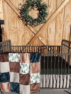 a baby crib with a wreath hanging on it