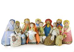 a group of nativity figurines sitting next to each other