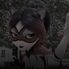 an animated cat woman with black and white face paint holding her arm up in the air