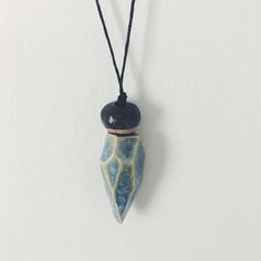 "These handmade necklaces are sure to delight! Each bead was made by hand and is unique and organic in form. This necklace features a bold, blue dipped geode pendant topped with a small accent bead. The simple and calming color palette goes with everything. Great for layering, and makes a beautiful gift. In stock and ready to ship. On 30\" cotton cord. Comes in a muslin gift pouch." Handmade Blue Long Drop Necklace, Handmade Blue Necklace With Long Drop, Handmade Blue Necklaces With Long Drop Shape, Artisan Hand Painted White Necklace, Ceramics Necklace, Ceramic Bead Necklace, Blue Artisan Polymer Clay Jewelry, Ceramic Necklace Jewellery, Ceramic Necklace Novica