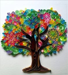 a colorful tree made out of paper with circles on it's trunk and leaves