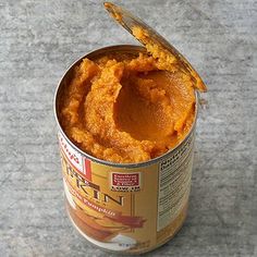 an open can of food with a spoon sticking out of it