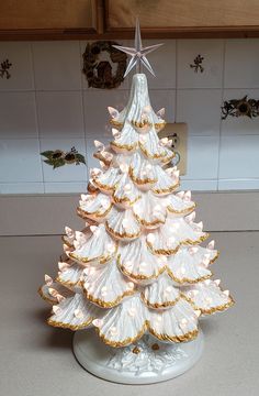 a white ceramic christmas tree on a counter