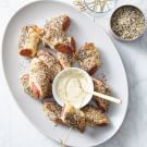 a white plate topped with chicken wings covered in ranch dressing