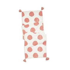 an orange and white polka dot blanket with tassels