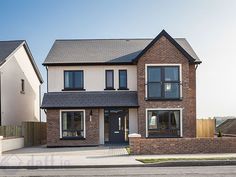 a two story brick house with black windows