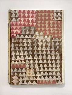 a piece of art that has been made out of old paper with triangles on it