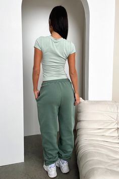 Cute and comfy in the Series 3 Sweatpants. This babe offers a soft fleeced inside, elasticated waistband with drawstrings, cuffed ankles and a puffed 'THATSSOFETCH' logo. Pair her with the matching hoodie and sneakers for an off duty cool girl look. FABRICATION: 65% Cotton 35% Polyester SIZING: Crystal's height is 162cm and wears a size AU6/US2 Fitted Cotton Joggers With Drawstring, Trendy Green Joggers, Trendy Joggers For Lounging, Basic Spring Joggers With Elastic Waistband, Trendy Green Joggers With Elastic Waistband, Trendy Solid Color Joggers For Loungewear, Casual Fitted Sweatpants With Drawstring, Fitted Casual Sweatpants With Drawstring, Fitted Casual Joggers With Ribbed Waistband