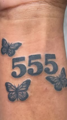 the number 555 with butterflies is on the side of this woman's stomach